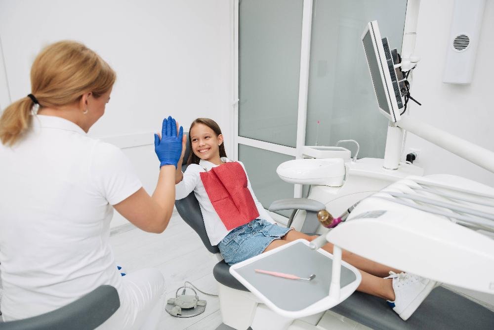 child smiling in exam chair | family dentist los gatos ca