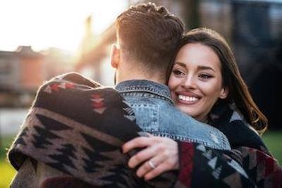 younger couple hugging outside | veneers los gatos ca