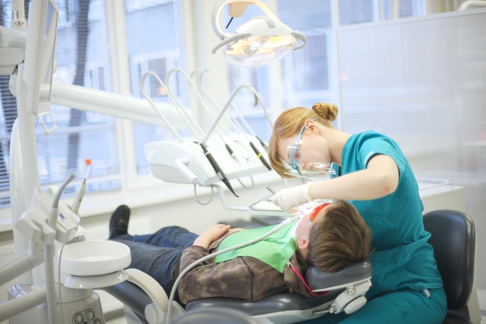 dental hygenist performing dental exam | cosmetic dentist los gatos ca