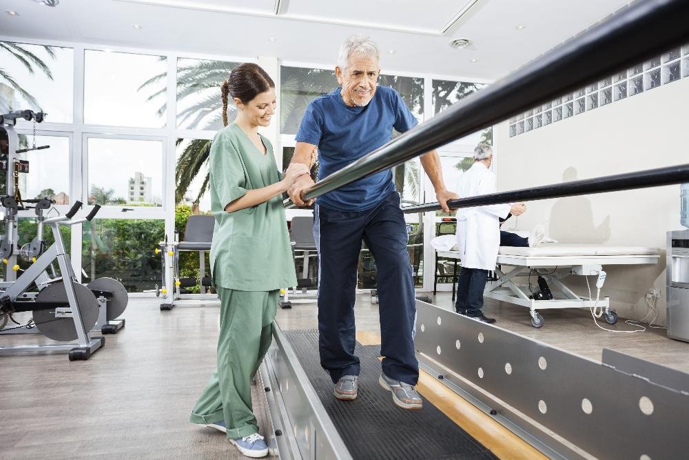 older man working with physical therapist | tooth-colored fillings los gatos