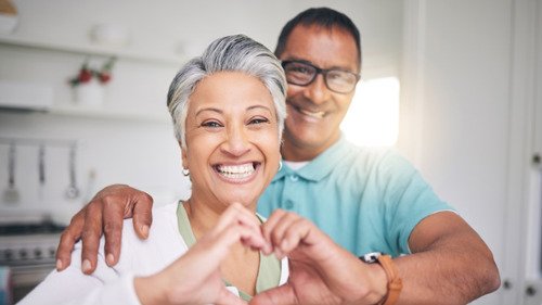 older couple making heart with hands | dentist los gatos