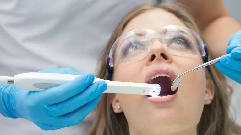 woman receiving dentist exam | white spot treatment los gatos